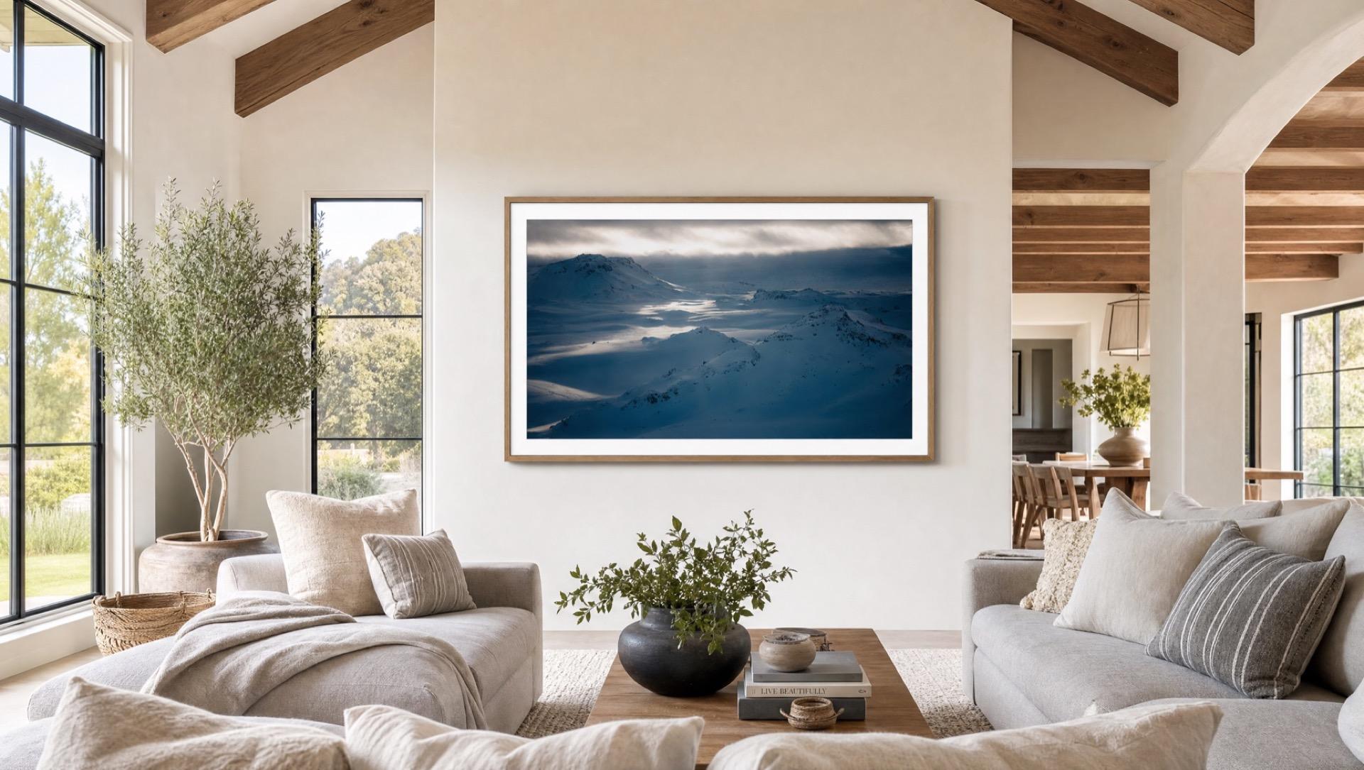 A Samsung The Frame TV showing a snow-covered mountain photo in a bright farmhouse living room